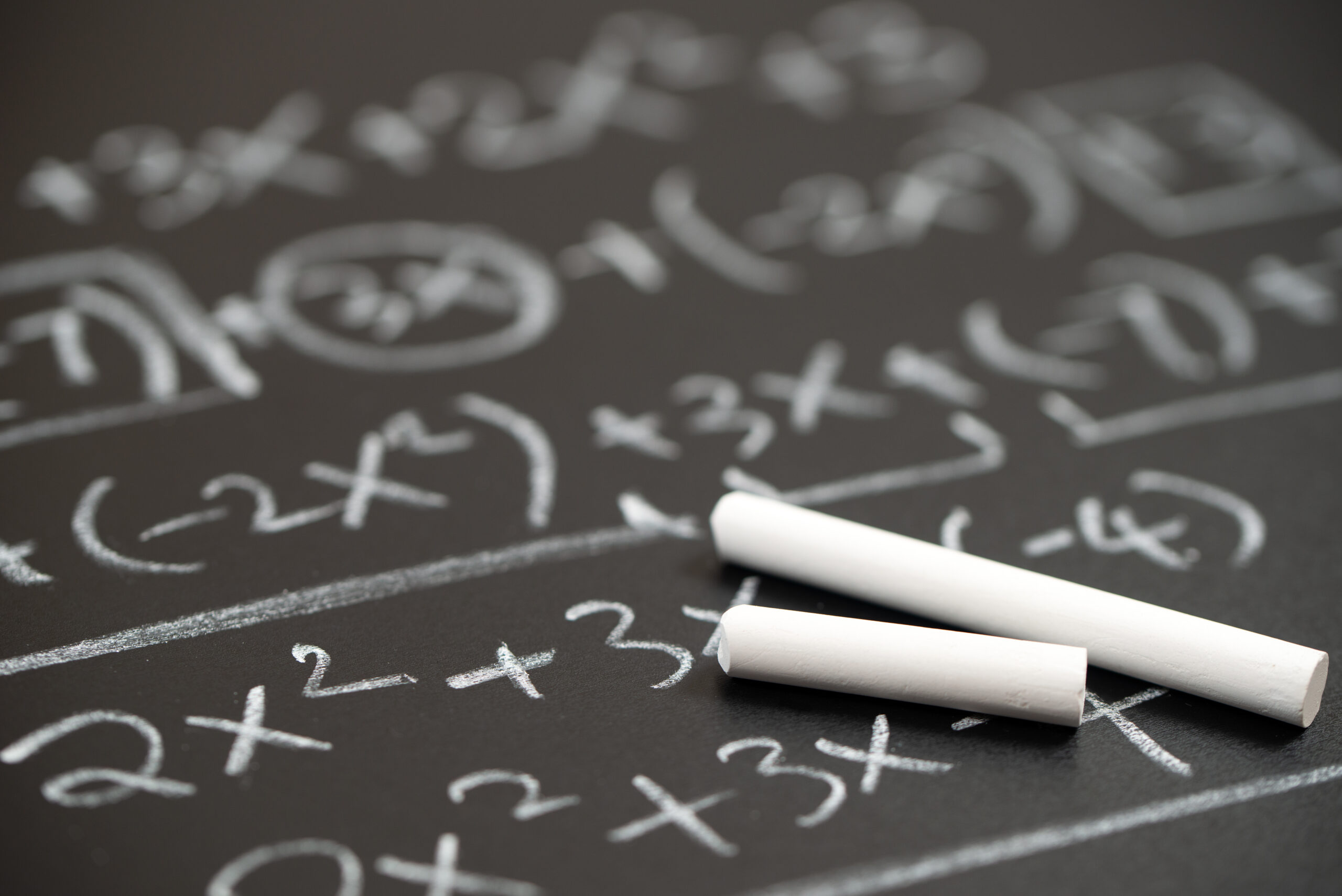 Algebra mathematic formula written on a chalkboard.