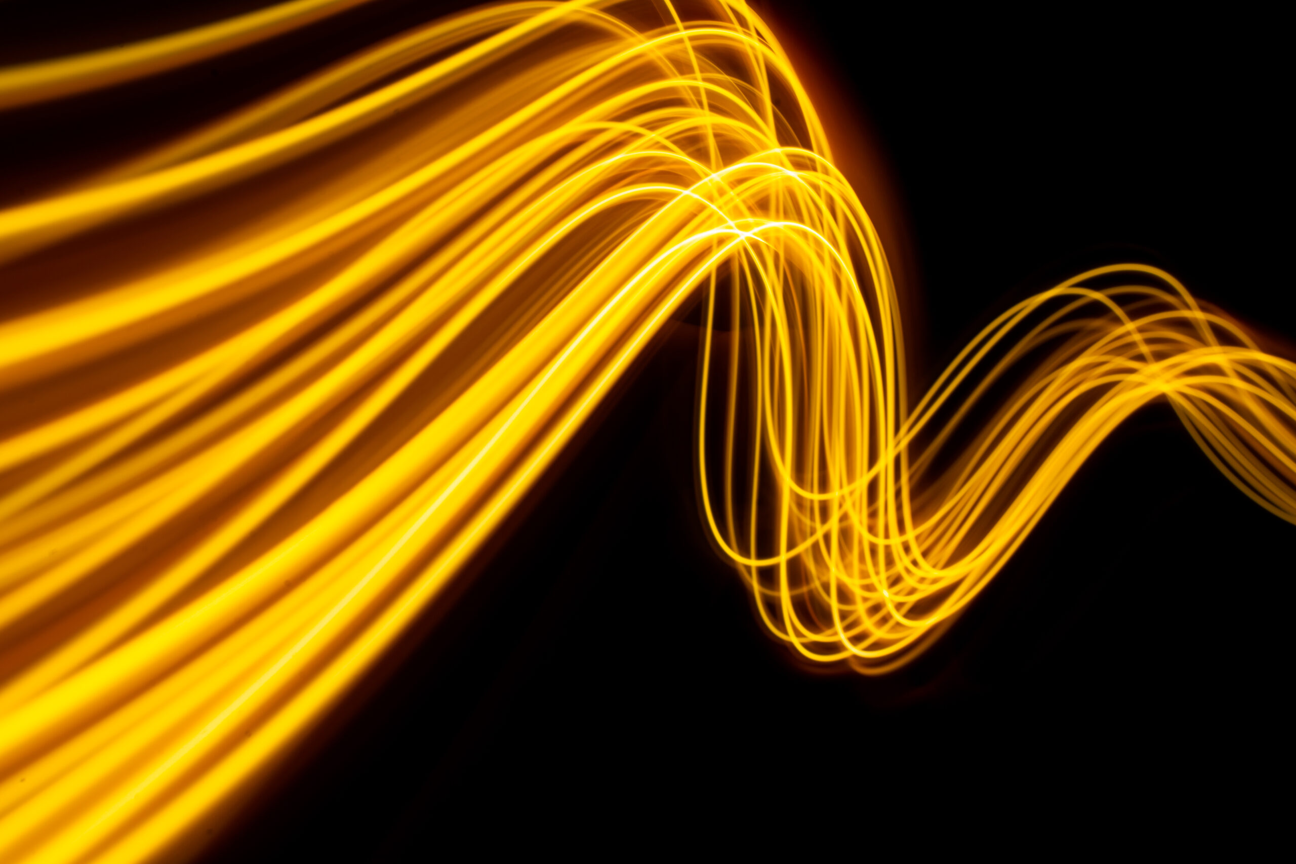 Futuristic wave of energy with a yellow glow.